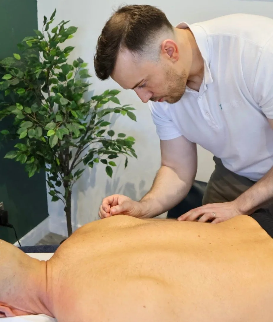 Josh Devine delivering hands on treatment to a patient's back